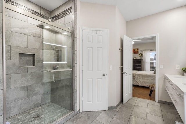 bathroom with tile patterned flooring, vanity, and an enclosed shower