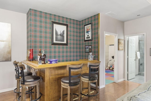 bar featuring light hardwood / wood-style floors