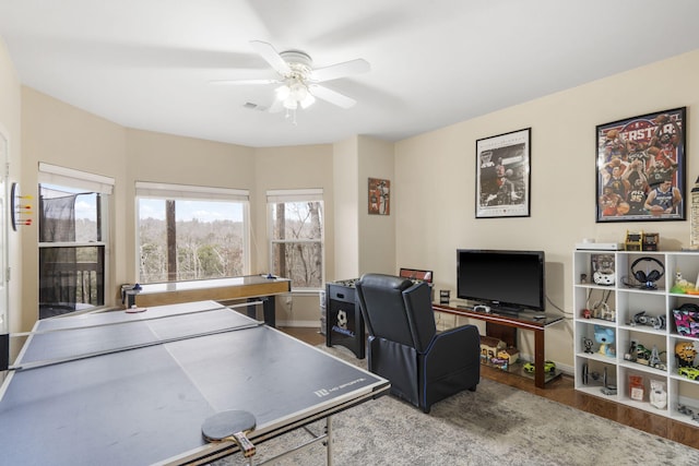 playroom with wood-type flooring and ceiling fan