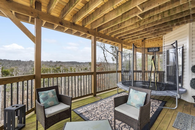 wooden deck with a trampoline