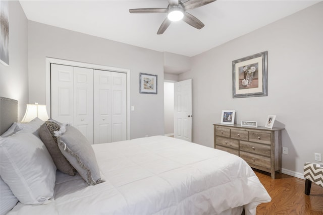 bedroom with ceiling fan, a closet, and hardwood / wood-style flooring