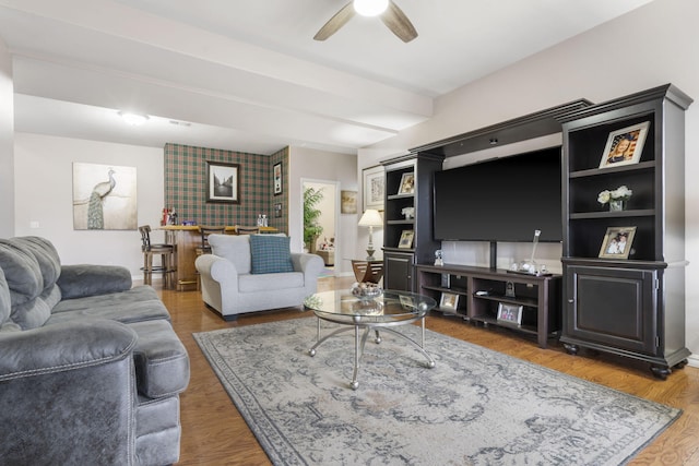 living room featuring hardwood / wood-style floors and ceiling fan