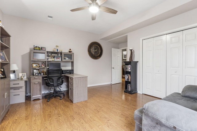 home office with ceiling fan and light hardwood / wood-style flooring