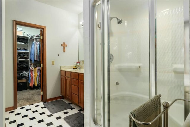 bathroom featuring vanity and a shower with door