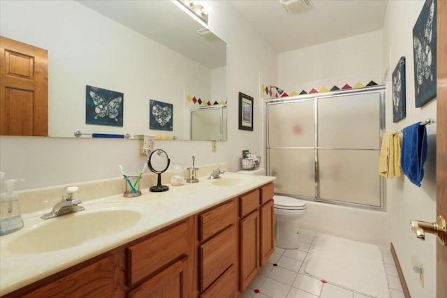 full bathroom featuring toilet, tile patterned flooring, vanity, and combined bath / shower with glass door