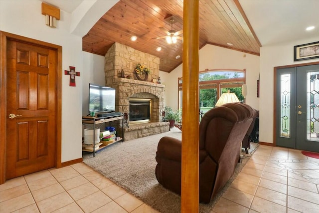 living room with ceiling fan, wooden ceiling, a fireplace, and light tile patterned floors