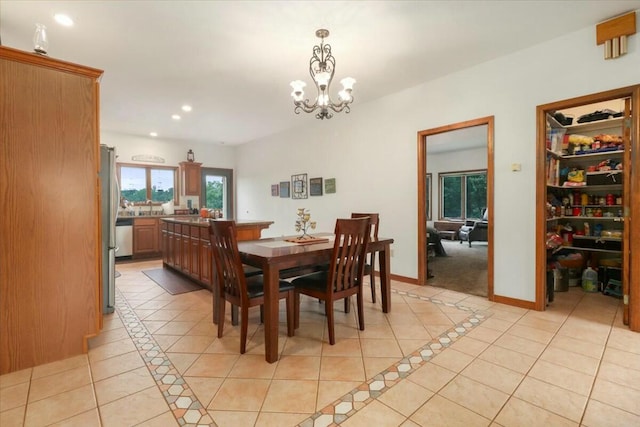 dining space with a chandelier and light tile patterned floors