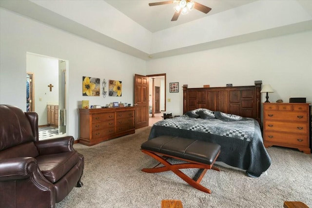 bedroom with light carpet, ensuite bath, and ceiling fan