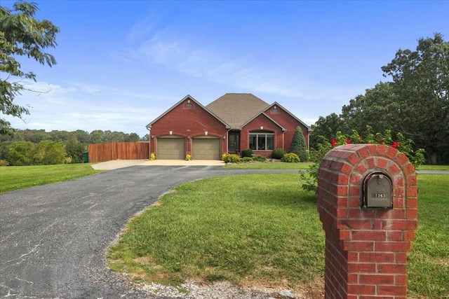 view of front facade with a front yard and a garage