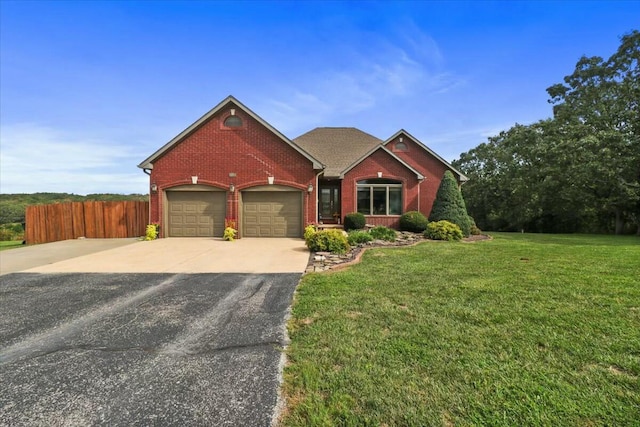 view of front of house with a front yard and a garage