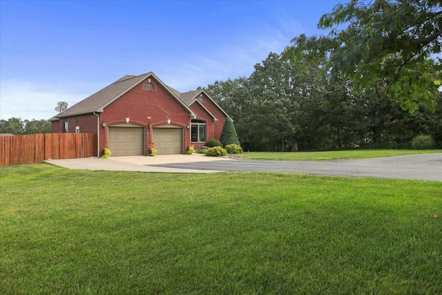 view of front of property with a front yard and a garage