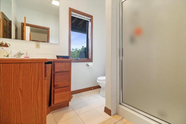 bathroom featuring tile patterned flooring, vanity, toilet, and an enclosed shower