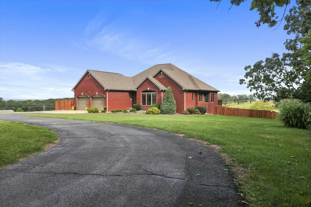 view of front of house featuring a garage and a front yard