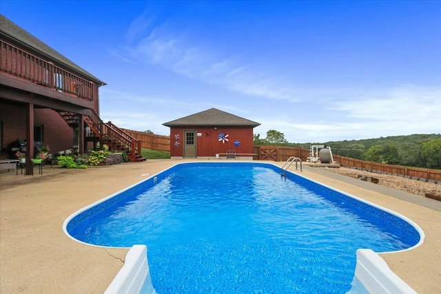 view of pool featuring a patio and an outdoor structure