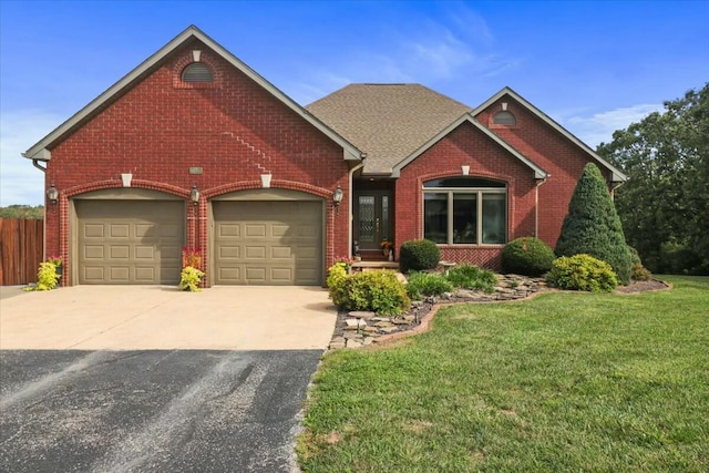 view of front facade with a front yard and a garage