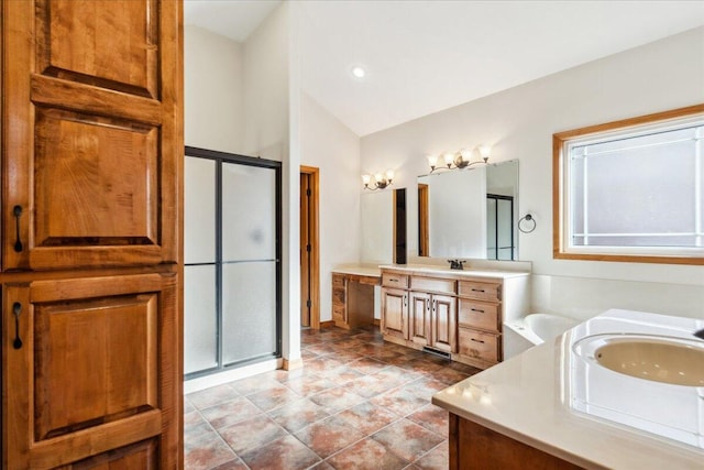 bathroom featuring walk in shower, lofted ceiling, and vanity