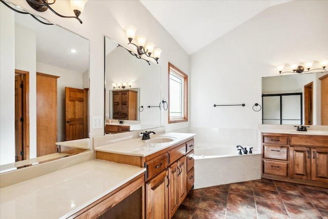 bathroom featuring vanity, a notable chandelier, vaulted ceiling, and a bath