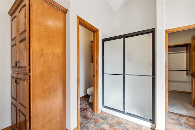 bathroom with toilet and walk in shower