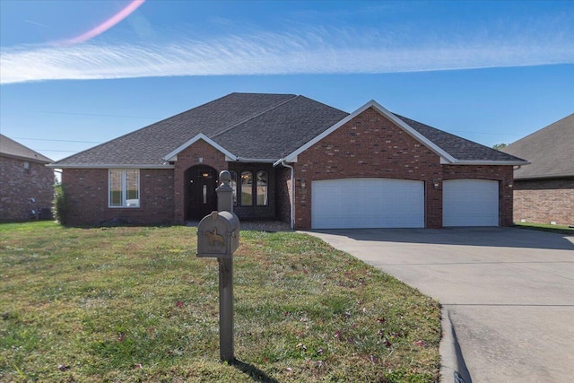 single story home featuring a garage and a front lawn