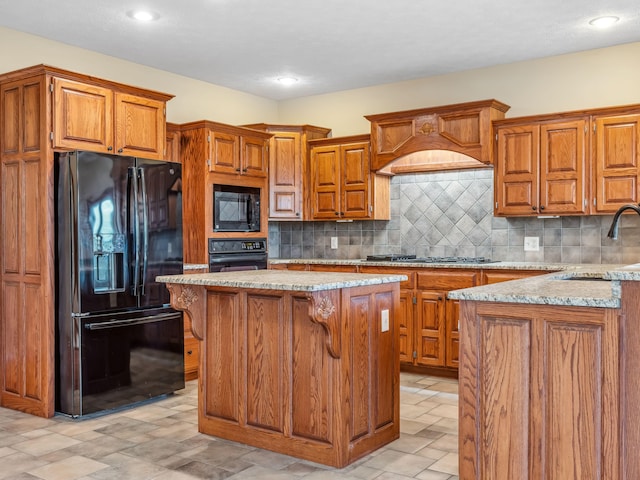 kitchen with backsplash, custom exhaust hood, sink, black appliances, and a center island