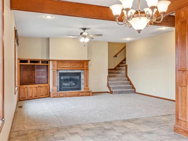 unfurnished living room featuring a fireplace, light colored carpet, and ceiling fan with notable chandelier