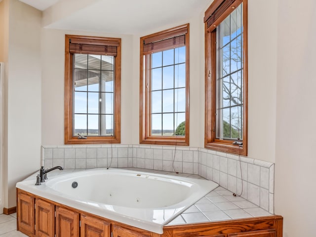 bathroom with tile patterned flooring and a bath