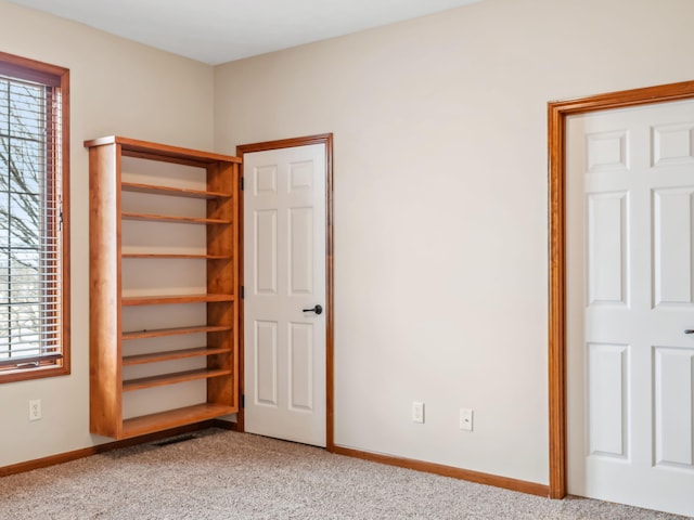 unfurnished bedroom with light colored carpet