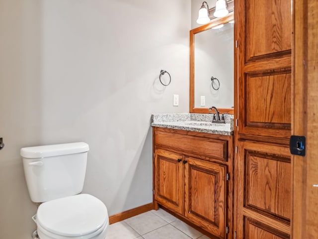 bathroom featuring tile patterned flooring, vanity, and toilet