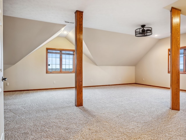 additional living space featuring carpet floors and vaulted ceiling