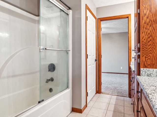 bathroom with tile patterned floors, vanity, and enclosed tub / shower combo