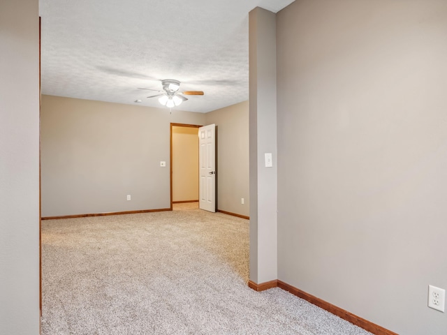 carpeted spare room with ceiling fan and a textured ceiling