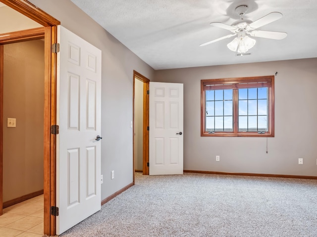 unfurnished bedroom with ceiling fan and light colored carpet