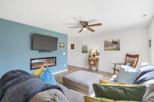 living room with ceiling fan and light hardwood / wood-style flooring