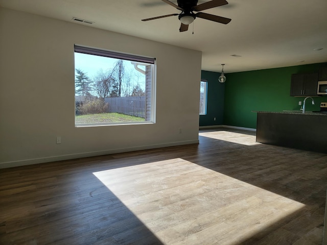 interior space with ceiling fan, dark hardwood / wood-style flooring, and sink