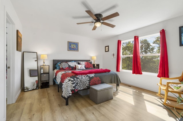 bedroom with ceiling fan and light hardwood / wood-style floors