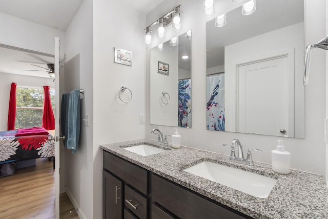 bathroom with hardwood / wood-style floors, vanity, and ceiling fan