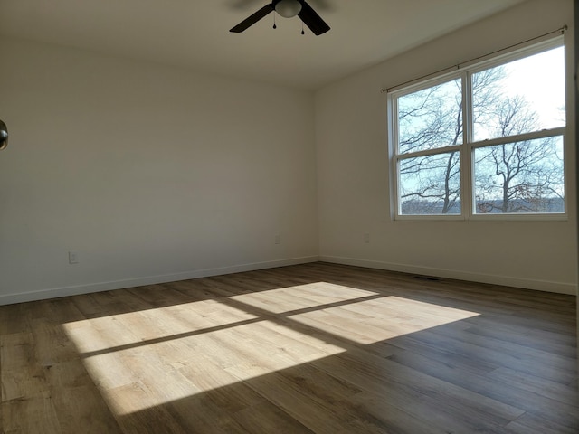 unfurnished room with ceiling fan and light wood-type flooring