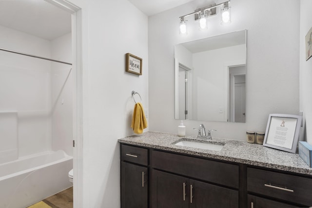 full bathroom with vanity, wood-type flooring, shower / bathtub combination, and toilet