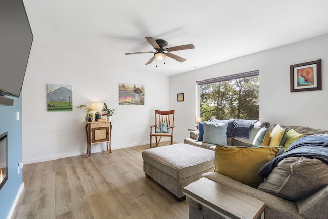 living room with ceiling fan and light hardwood / wood-style floors