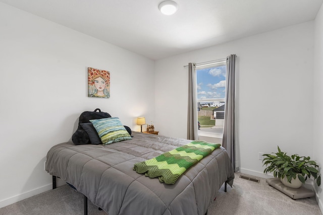 bedroom featuring light colored carpet