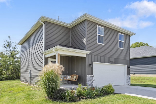 view of front of home featuring a front yard and a garage