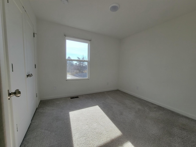 spare room with light colored carpet