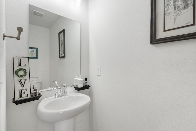 bathroom with sink and toilet