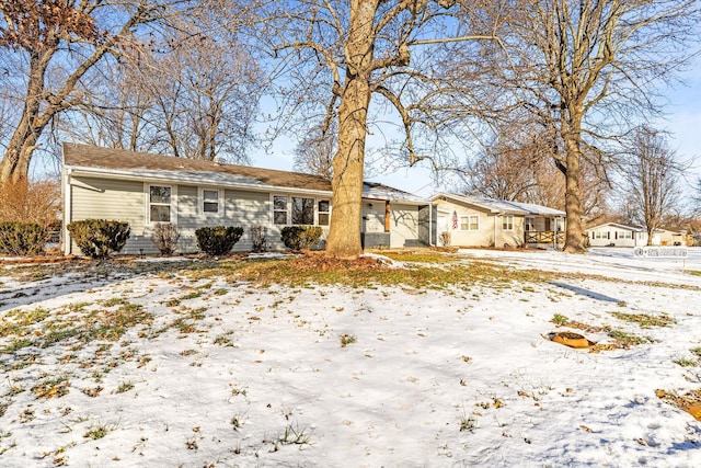 view of snow covered rear of property