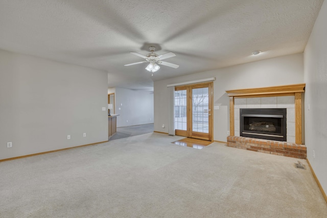 unfurnished living room with carpet flooring, ceiling fan, and a textured ceiling