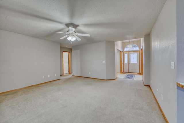 empty room with a textured ceiling, light carpet, and ceiling fan with notable chandelier