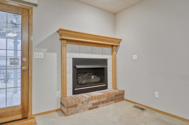 interior details featuring carpet floors and a brick fireplace