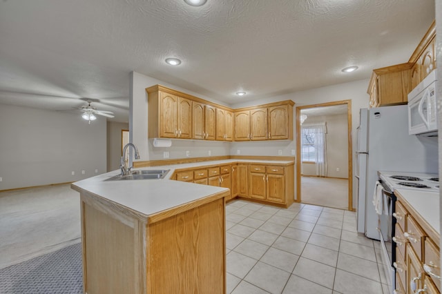 kitchen featuring ceiling fan, sink, light brown cabinets, kitchen peninsula, and white appliances