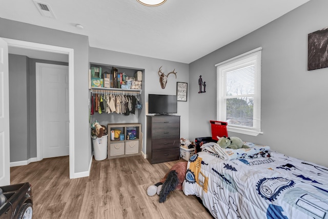 bedroom with hardwood / wood-style flooring and a closet