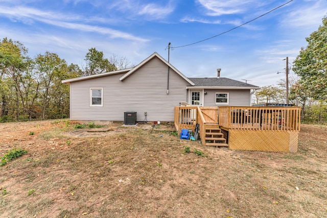 rear view of house with a deck and central AC